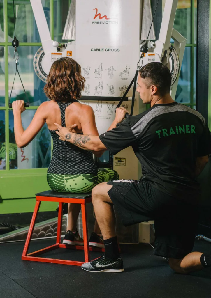 Elite Training trainer coaching woman on gym equipment